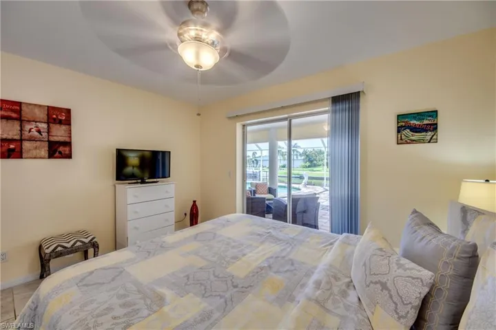 Bedroom with access to outside and a ceiling fan