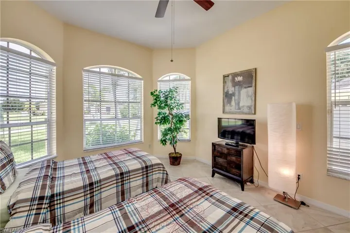 Bedroom featuring light tile patterned floors and ceiling fan