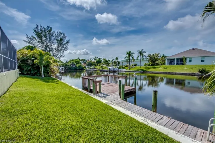 Dock with a yard and a water view