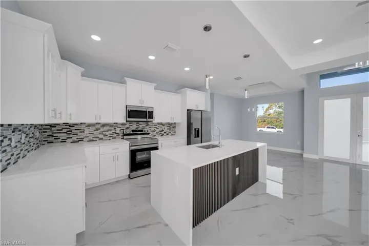 Kitchen featuring visible vents, recessed lighting, a sink, stainless steel appliances, and decorative backsplash
