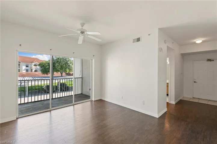 Unfurnished room with a ceiling fan and wood finished floors