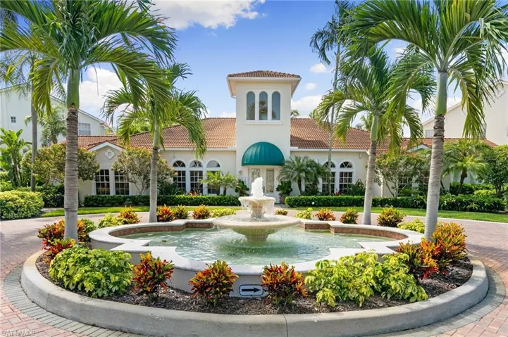 View of building exterior featuring curved driveway