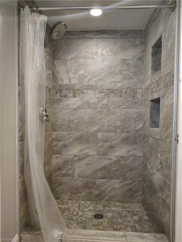 Full bath featuring a shower stall