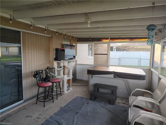 View of patio / terrace with fence and a hot tub