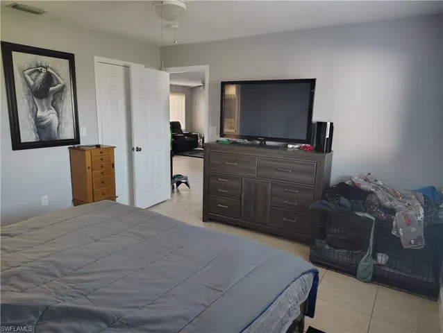 Bedroom with visible vents and light tile patterned floors