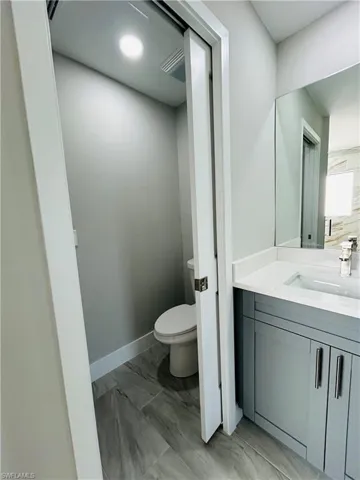Bathroom featuring vanity and private toilet