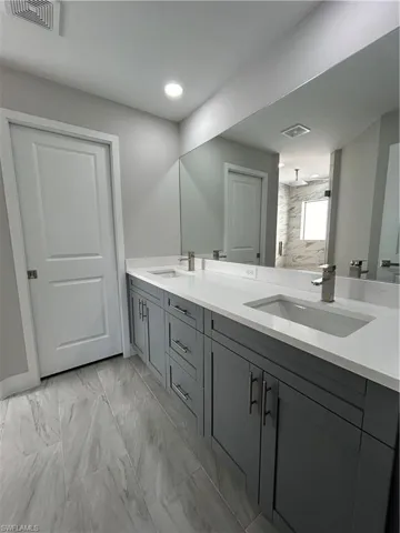 Bathroom with vanity, dual sink