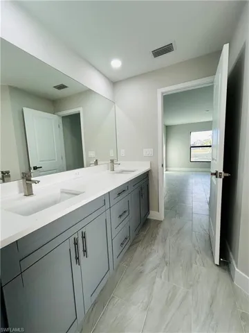 Bathroom featuring vanity, dual sink