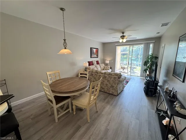 Dining room with hardwood / wood-style flooring and ceiling fan