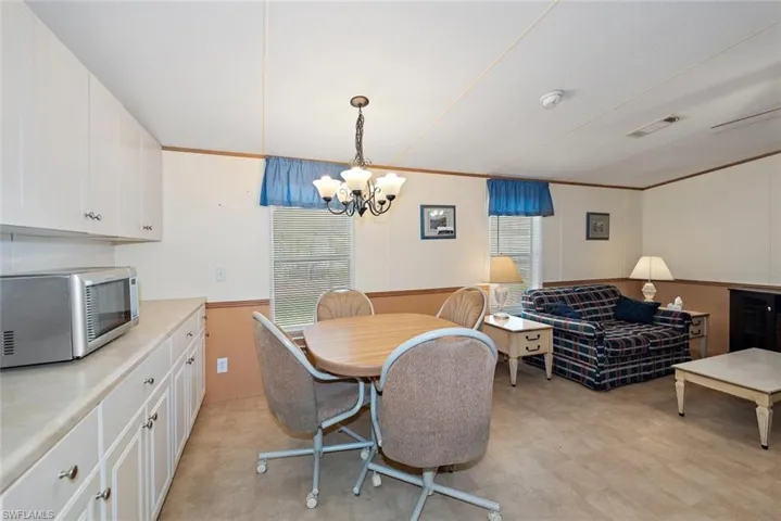 Dining space featuring a chandelier and wainscoting
