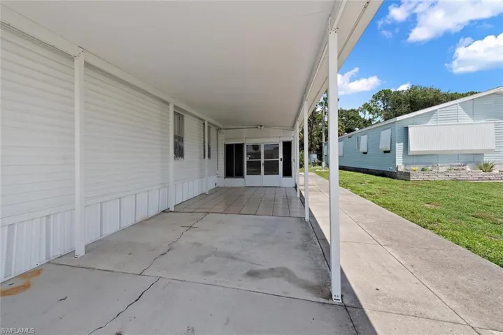 View of patio with a carport