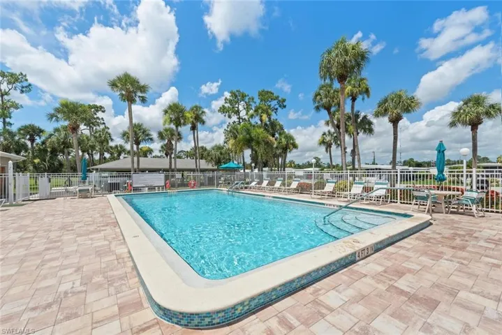 Community pool with a patio