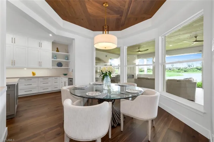 Dining space featuring wood ceiling, dark wood-type flooring, and ceiling fan