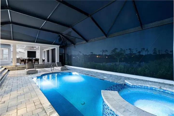View of swimming pool featuring an in ground hot tub and a patio area