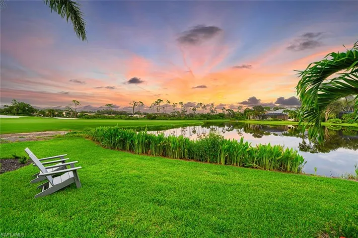 View of property's community with a yard and a water view