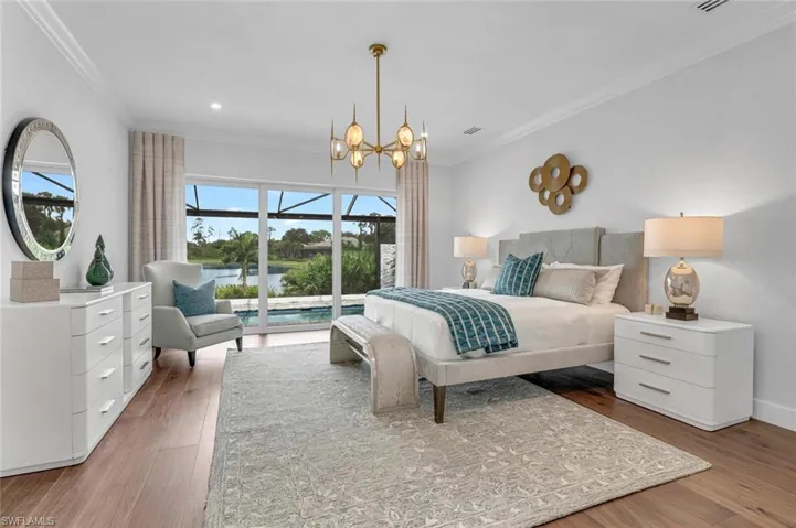 Bedroom with ornamental molding, a notable chandelier, hardwood / wood-style flooring, and access to outside