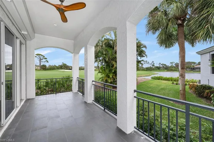 Balcony with a water view and ceiling fan