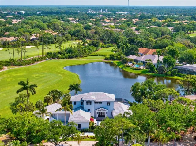 Birds eye view of property with a water view