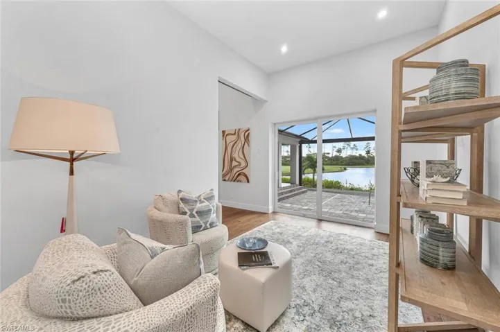 Living room with a water view and wood-type flooring