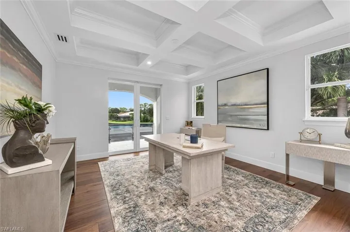 Office area with ornamental molding, beam ceiling, coffered ceiling, and dark wood-type flooring