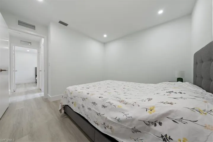 Bedroom with light wood-style floors and recessed lighting