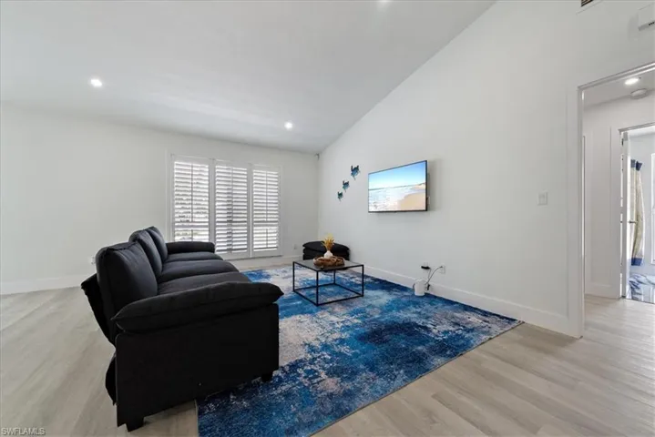 Sitting room featuring light wood-style floors, recessed lighting, and vaulted ceiling
