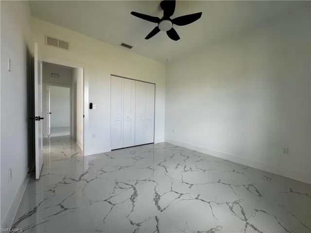Unfurnished bedroom featuring a closet and ceiling fan