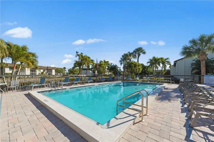 Community pool with a patio