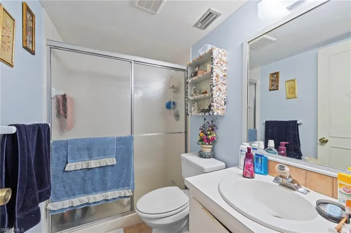 Bathroom with vanity and a stall shower