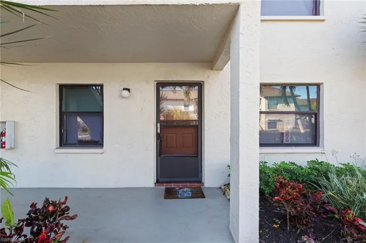 Property entrance featuring stucco siding
