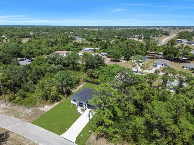 Contemporary single-story residence with a dark shingle roof and white exterior