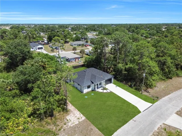 Single-story residence featuring a dark shingle roof, white exterior siding, and an attached two-car garage