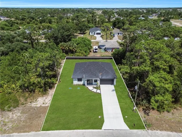 Contemporary single-story residence with a dark shingle roof and a light-colored exterior finish