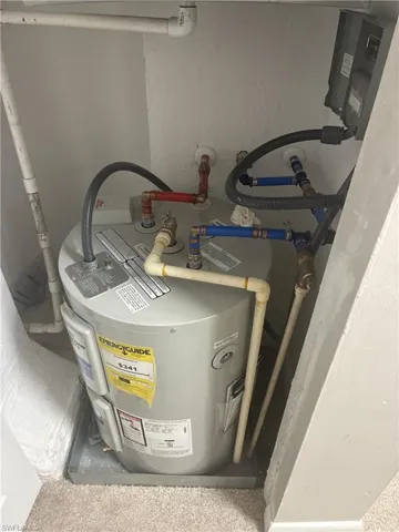 Water heater unit with associated plumbing NEW connections and a metal drip pan