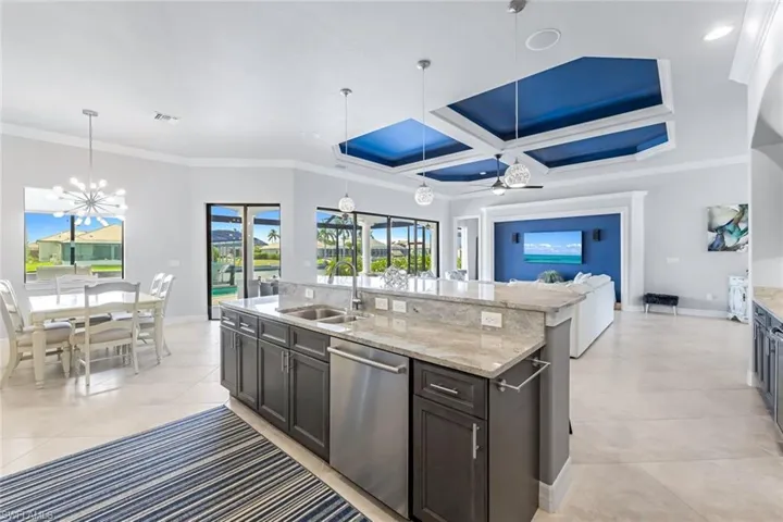 Kitchen featuring sink, coffered ceiling, stainless steel dishwasher, and crown molding