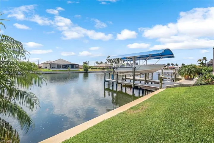 Dock area featuring a lawn and a water view