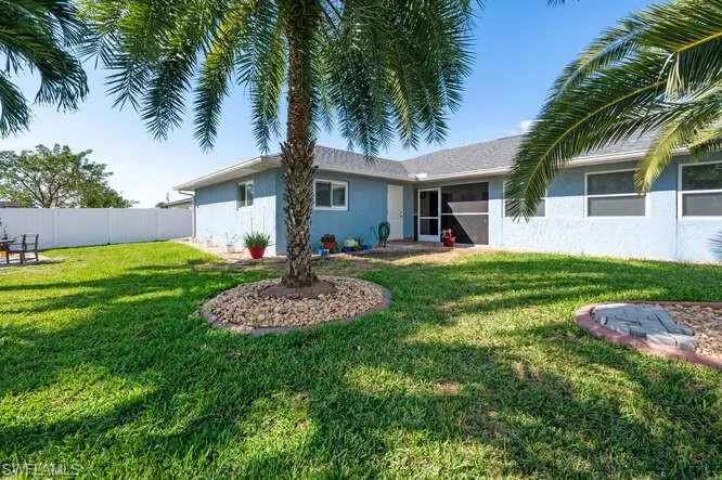 Rear view of property featuring a lawn