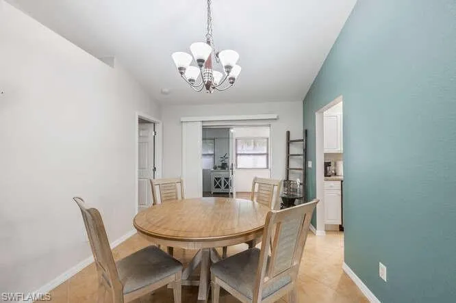 Tiled dining area with an inviting chandelier
