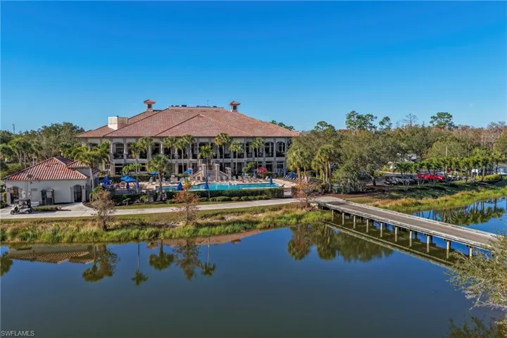 Back of property featuring a water view and a patio area