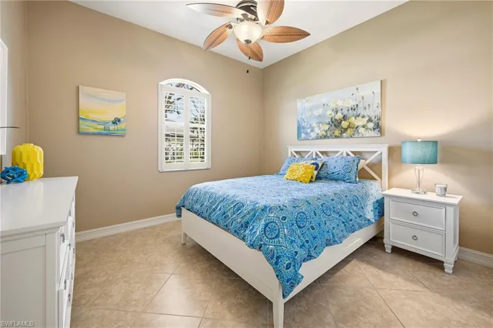 Bedroom with a ceiling fan and light tile patterned floors