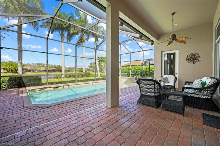 View of patio with a sunroom, an outdoor pool, a lanai, a ceiling fan, and outdoor furniture