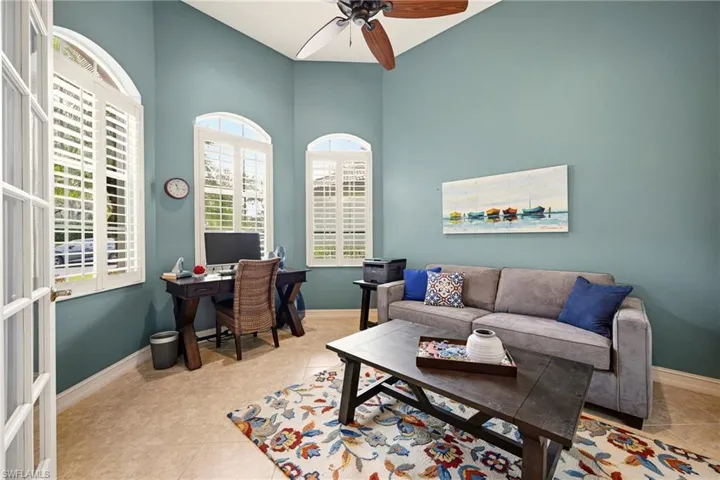 Office space featuring plenty of natural light, light tile patterned floors, and ceiling fan