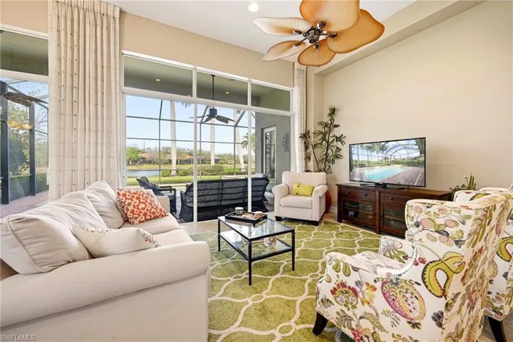 Living room featuring a sunroom, a ceiling fan, healthy amount of natural light, wood finished floors, and recessed lighting