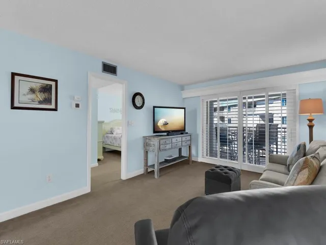 Living room with carpet flooring and baseboards