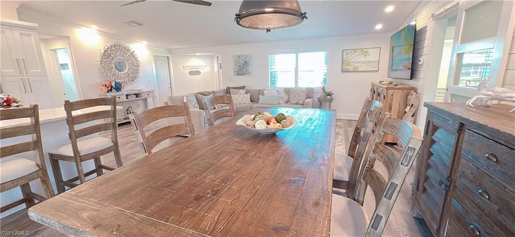 Spacious open-concept interior featuring light wood-finish flooring, recessed lighting, a ceiling fan, and white interior walls
