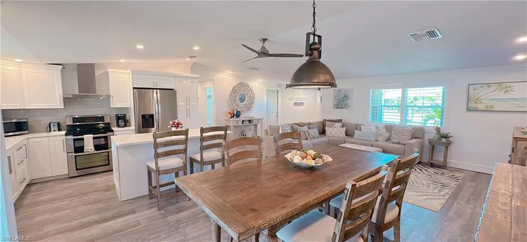 Open-concept living space featuring a kitchen, dining area, and living room