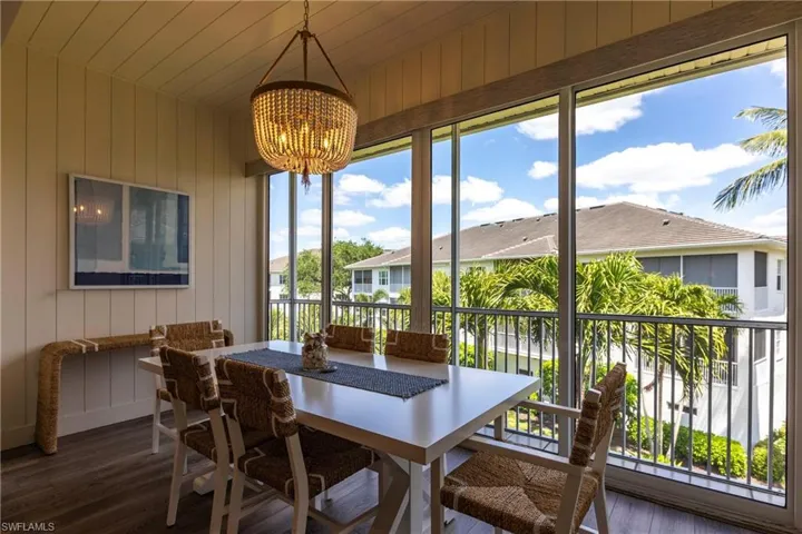 Sunroom / solarium featuring an inviting chandelier and a residential view