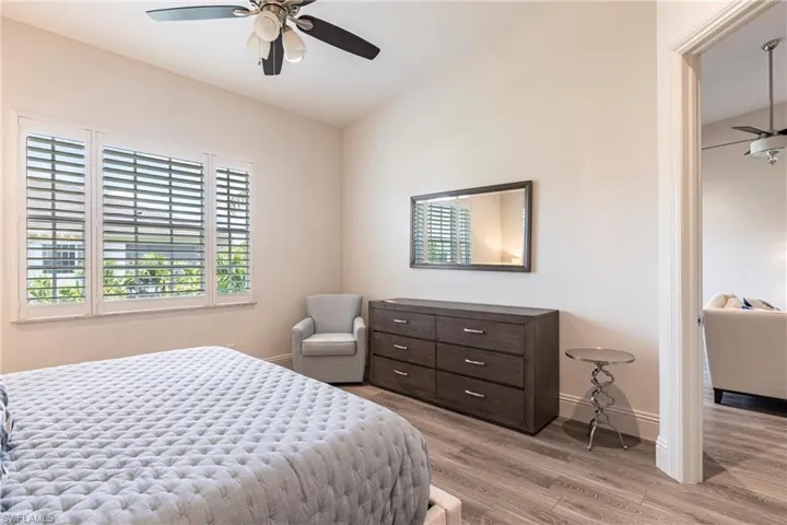 Bedroom with baseboards, wood finished floors, and ceiling fan