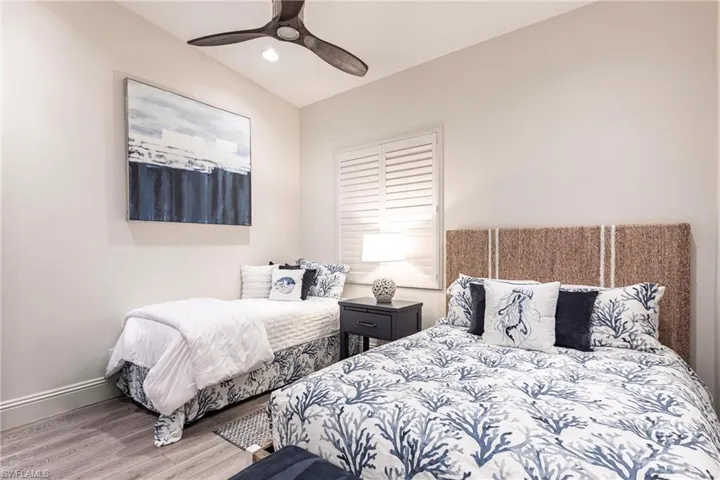 Bedroom with wood finished floors, a ceiling fan, recessed lighting, and baseboards