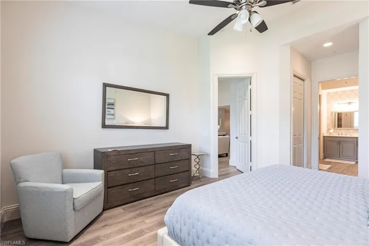 Bedroom with recessed lighting, ensuite bath, light wood-style flooring, a sink, and a ceiling fan